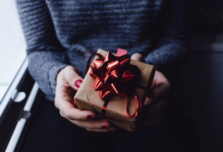 person holding the red gift