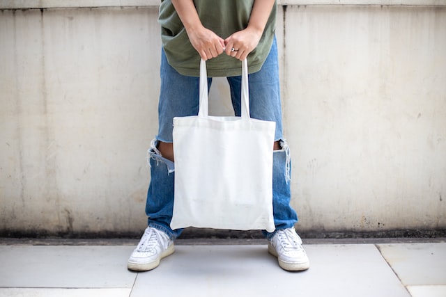 person holding white bag