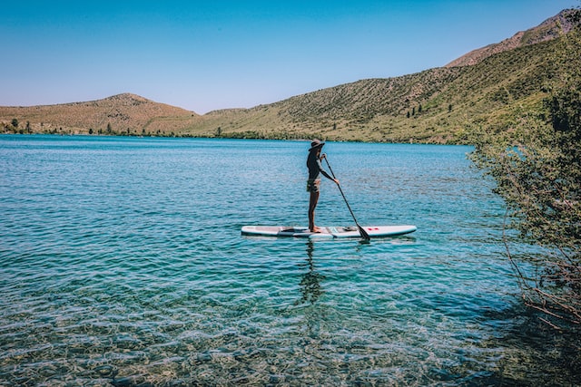 person in black riding on black kayak