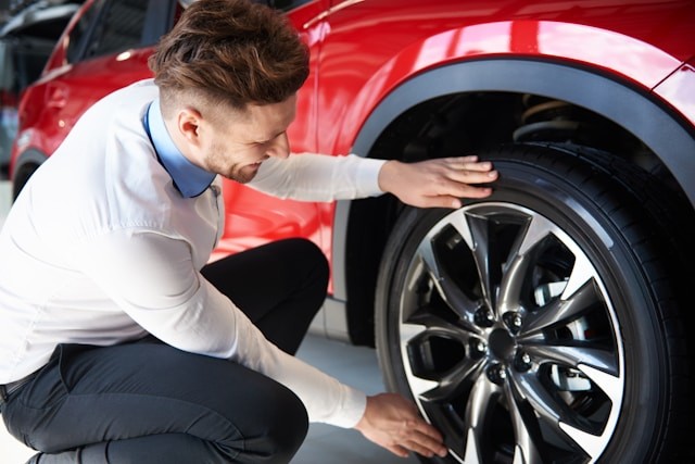 person inspecting wheel