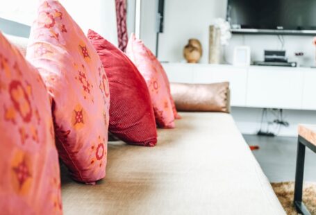 pile-of-four-pink-throw-pillows-on-sofa