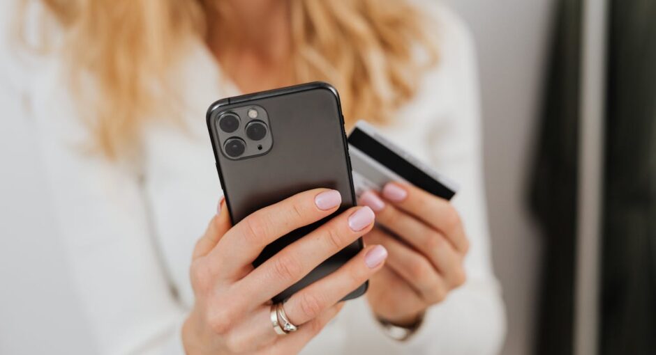 close-up-shot-of-a-person-holding-a-credit-card-and-a-smartphone