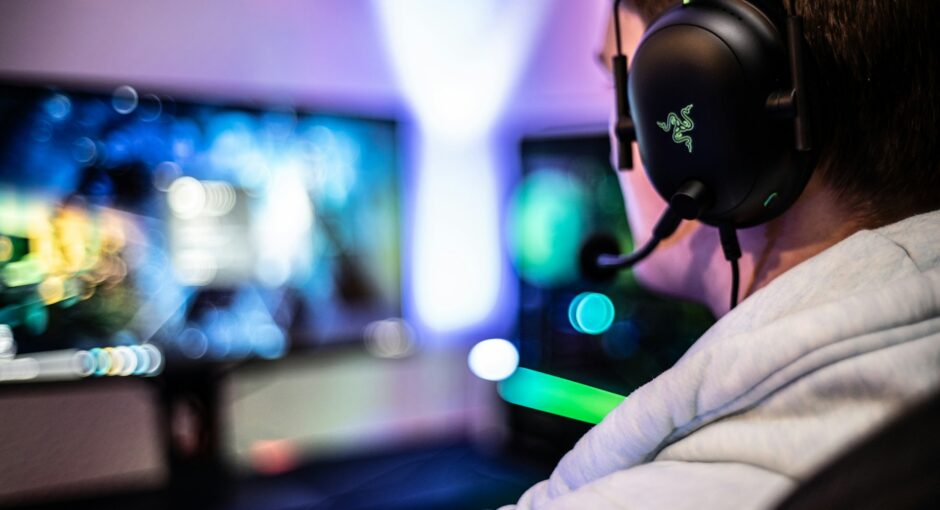 a-man-wearing-a-headset-and-using-a-computer